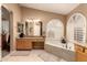 Spa-like bathroom featuring a corner tub and dual vanities at 1435 E Oxford Ln, Gilbert, AZ 85295