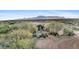 Aerial view of house and surrounding landscape with mountains in the background at 14705 E Redbird Rd, Scottsdale, AZ 85262
