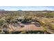 Aerial view of a ranch style home with paddocks and mountain views at 14705 E Redbird Rd, Scottsdale, AZ 85262