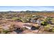 Aerial view of a large estate with a main house, stables, and paddocks at 14705 E Redbird Rd, Scottsdale, AZ 85262