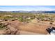 Aerial view of a horse ranch with stables, paddocks and a main house at 14705 E Redbird Rd, Scottsdale, AZ 85262