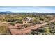 Aerial view of a desert home with a long driveway and mountain backdrop at 14705 E Redbird Rd, Scottsdale, AZ 85262