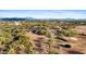 Aerial view of a ranch property with multiple buildings and horse stables at 14705 E Redbird Rd, Scottsdale, AZ 85262