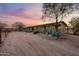 Barn with stalls and desert landscaping at sunset at 14705 E Redbird Rd, Scottsdale, AZ 85262
