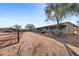 Long barn with multiple stalls and desert landscaping at 14705 E Redbird Rd, Scottsdale, AZ 85262