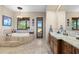 Spa-like bathroom with a large soaking tub and double vanity at 14705 E Redbird Rd, Scottsdale, AZ 85262