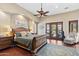 Main bedroom features a king bed, patio access, and wood floors at 14705 E Redbird Rd, Scottsdale, AZ 85262