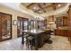 Gourmet kitchen features granite island, custom cabinetry, and high-end appliances at 14705 E Redbird Rd, Scottsdale, AZ 85262