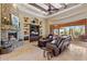 Spacious living room with stone fireplace, large windows, and comfortable seating at 14705 E Redbird Rd, Scottsdale, AZ 85262
