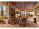 Covered patio with stone fireplace, creating a cozy ambiance at 14705 E Redbird Rd, Scottsdale, AZ 85262