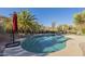 Sparkling kidney-shaped pool surrounded by desert landscaping and palm trees at 14944 E Zapata Dr, Fountain Hills, AZ 85268