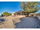 Spacious backyard with gravel and mature trees, offering privacy and outdoor space at 15827 W Falcon Ridge Dr, Sun City West, AZ 85375