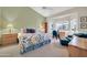 Spacious bedroom with king-size bed, built-in shelving, and window seat at 15827 W Falcon Ridge Dr, Sun City West, AZ 85375