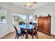 Cozy dining area with round table, four chairs, and built in shelving at 15827 W Falcon Ridge Dr, Sun City West, AZ 85375