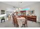 Bright dining area with a table, chairs, and a piano at 15827 W Falcon Ridge Dr, Sun City West, AZ 85375