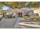 Single-story home with attractive landscaping and a paved walkway at 15827 W Falcon Ridge Dr, Sun City West, AZ 85375