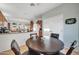 Bright kitchen with wood cabinets, breakfast bar, and view into dining area at 15827 W Falcon Ridge Dr, Sun City West, AZ 85375