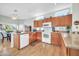 Kitchen with wood cabinets, granite counters, and island at 15827 W Falcon Ridge Dr, Sun City West, AZ 85375