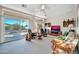 Relaxing living room with large windows, comfortable seating, and flat-screen TV at 15827 W Falcon Ridge Dr, Sun City West, AZ 85375