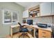 Home office with built-in cabinetry, desk, and a printer at 15827 W Falcon Ridge Dr, Sun City West, AZ 85375