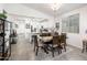 Bright dining room with a rustic table and access to the kitchen at 17734 W Amber Ridge Way, Goodyear, AZ 85338