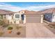 Single-story home with a two-car garage and a well-manicured front yard at 17734 W Amber Ridge Way, Goodyear, AZ 85338