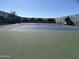 Well-maintained tennis court with seating areas at 17734 W Amber Ridge Way, Goodyear, AZ 85338