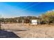 View of backyard with dirt area and animal enclosure at 2070 N Don Peralta Rd, Apache Junction, AZ 85119