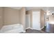 Bathroom featuring a soaking tub, shower, and linen closet at 219 E Beth Dr, Phoenix, AZ 85042