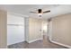 Bedroom with wood floors, closet, and ceiling fan at 219 E Beth Dr, Phoenix, AZ 85042