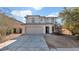 Two-story house with a beige exterior, two-car garage, and landscaping at 219 E Beth Dr, Phoenix, AZ 85042