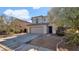 Two-story house with a beige exterior, two-car garage, and gravel driveway at 219 E Beth Dr, Phoenix, AZ 85042
