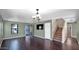Living room with dark hardwood floors, neutral walls, and a staircase at 219 E Beth Dr, Phoenix, AZ 85042