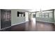 Living room with dark hardwood floors, neutral walls, and a dark door at 219 E Beth Dr, Phoenix, AZ 85042
