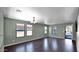 Living room with dark hardwood floors, neutral walls, and a view of the kitchen at 219 E Beth Dr, Phoenix, AZ 85042