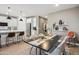 Modern dining area with black table and neutral chairs at 22846 E Watford Dr, Queen Creek, AZ 85142