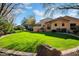 Spacious backyard with lush lawn and partial home view at 2333 S Eileen Pl, Chandler, AZ 85286