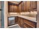 Wet bar with dark wood cabinets and granite countertops at 2333 S Eileen Pl, Chandler, AZ 85286