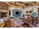 Living room with hardwood floors, stone fireplace, and built-in entertainment center at 2333 S Eileen Pl, Chandler, AZ 85286