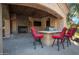 Outdoor kitchen with fireplace and seating for entertaining at 2333 S Eileen Pl, Chandler, AZ 85286