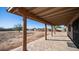 Covered patio with wood posts and tile flooring overlooks a large backyard at 2533 W Tanya Rd, Phoenix, AZ 85086