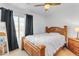 Bedroom with wood bed frame and dark curtains at 2957 E Erie Ct, Gilbert, AZ 85295