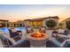 Cozy backyard fire pit with comfortable seating and pool view at 31023 N 117Th Dr, Peoria, AZ 85383