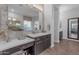 Stylish bathroom featuring dual vanities and a view of the shower and tub at 31023 N 117Th Dr, Peoria, AZ 85383
