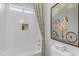 Bathroom with white subway tile, shower niche, and decorative shower curtain at 31023 N 117Th Dr, Peoria, AZ 85383