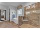 Bright bathroom with a soaking tub, a glass-enclosed shower, and stylish fixtures at 31023 N 117Th Dr, Peoria, AZ 85383