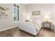 Cozy bedroom with hardwood floors, a comfortable bed with yellow accents, and matching bedside tables at 31023 N 117Th Dr, Peoria, AZ 85383