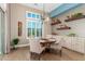 Dining room with a decorative chandelier, hardwood floors, with access to the backyard at 31023 N 117Th Dr, Peoria, AZ 85383