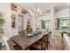Open-concept dining room with wood table and view of living area at 31023 N 117Th Dr, Peoria, AZ 85383