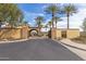 Gated community entrance with elegant architecture and landscaping at 31023 N 117Th Dr, Peoria, AZ 85383